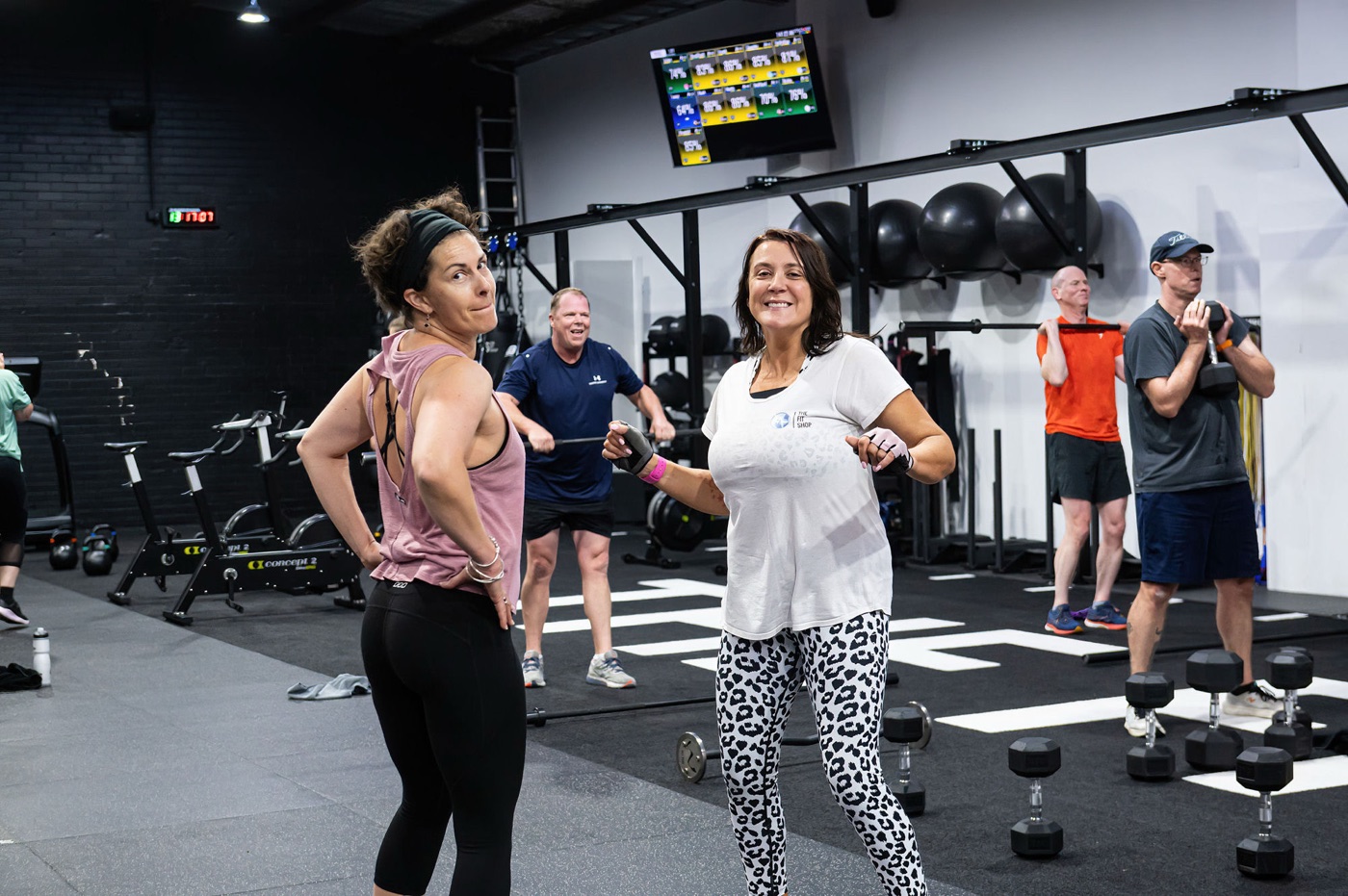 Two members laughing together during a bootcamp class